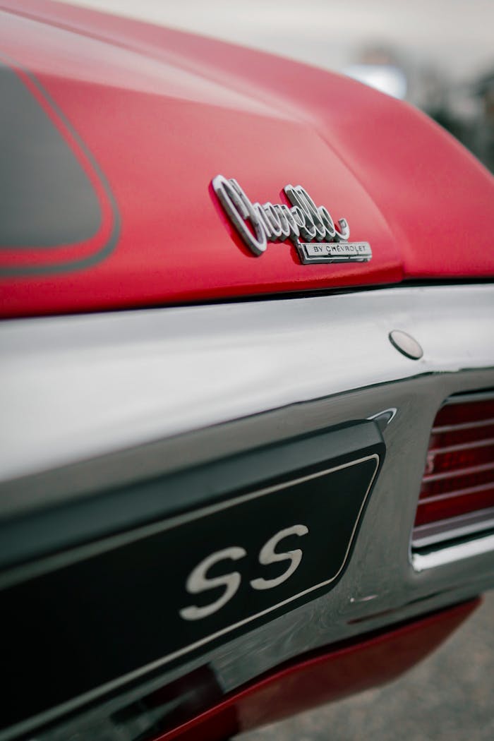 Classic Chevrolet Chevelle SS badge on a red vintage car captured in close-up.