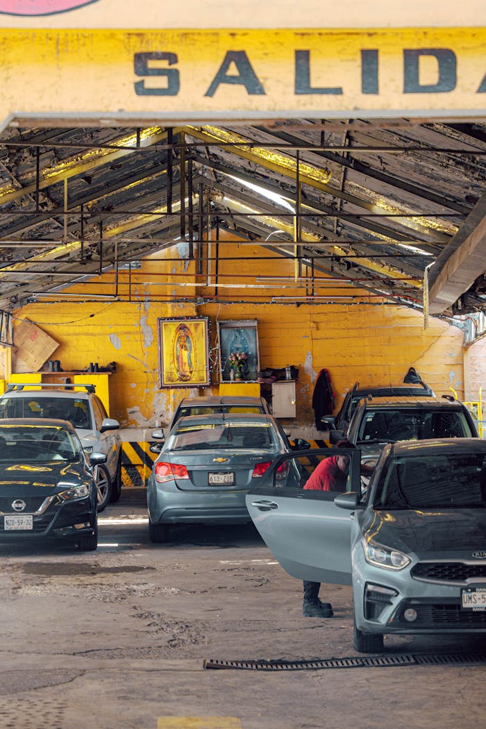 Interior of a bustling auto repair shop with cars being serviced, showcasing the garage setup.