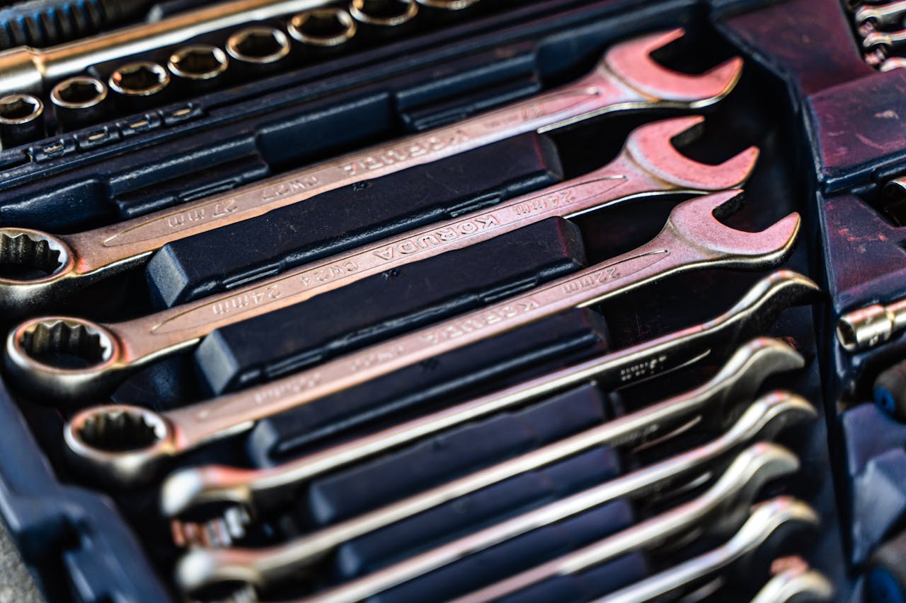 Detailed shot of a neatly arranged set of wrenches in a toolbox.